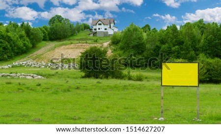One house up the hill surrounded by green trees and one panel to add text in the foreground
