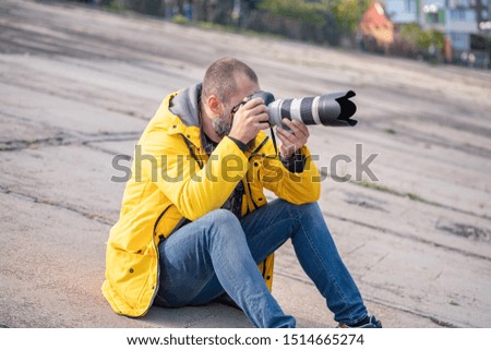 male Professional photographer taking a picture outdoor