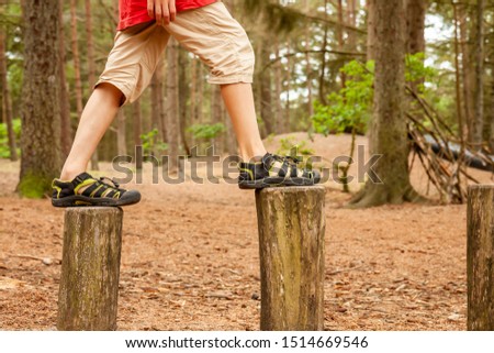 Boy balancing on trees - jumping from one to the other.