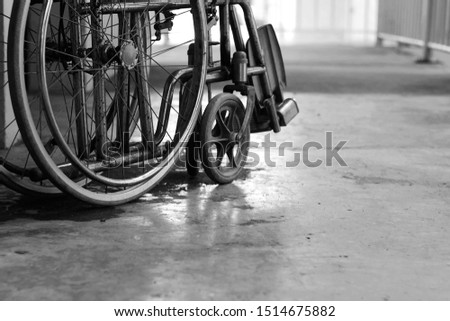 close up wheel of wheelchair for patient at hospital, world health day, medical and healthcare, life insurance business technology concept, black and white tone