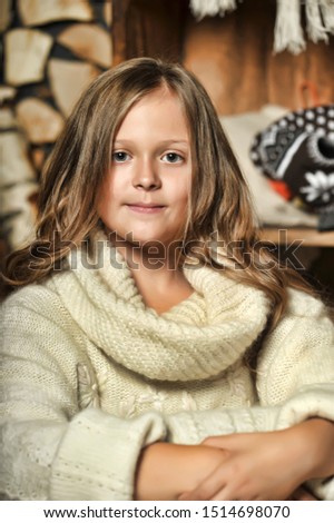 Portrait of a teenage girl and a big white sweater.