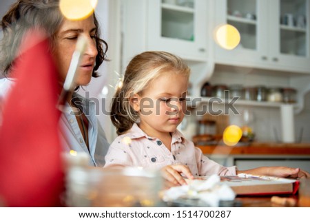 Mother learning her daughter to read