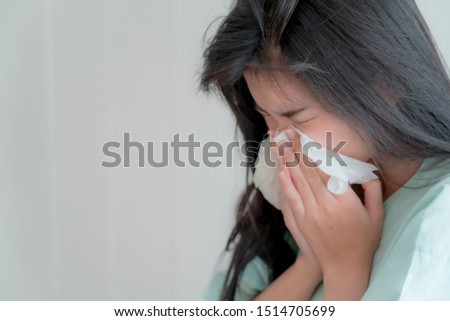 Sick young woman with seasonal infections flu, high fever and got nose allergy, sneezing nose.