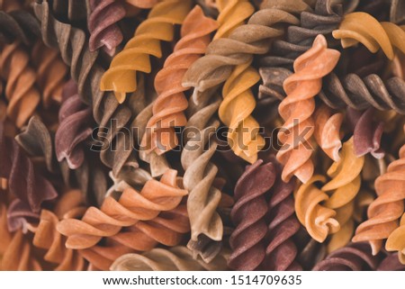 Colorful dry fusilli pasta closeup. Cooking tasty dinner. Selective focus.