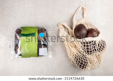 Cotton String Mesh Bag with Avocado VS prepacked avocado, Ecological zero waste and say no to plastic concepts Royalty-Free Stock Photo #1514726630