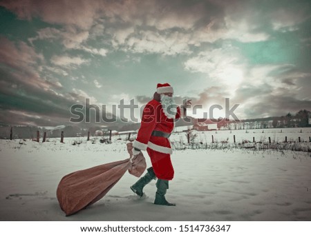 Santa Claus with a bag full of gifts, walking through a magical wonderful snowy landscape with a cloudy sky.