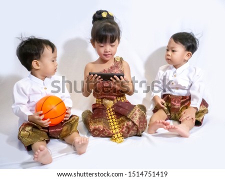 Thai little boy and girl in traditional Thai costume in white background