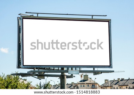 Blank white billboard for advertisement on the residential area. Sunny summer day in the city.