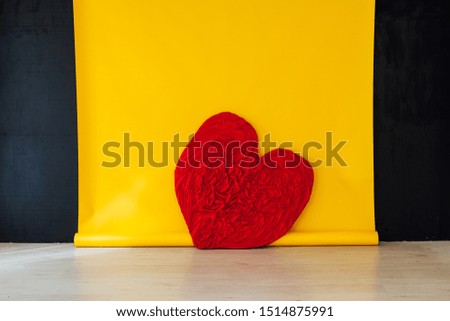 red heart in the interior of the room with a yellow background
