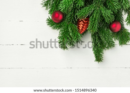 Christmas new Years background in retro vintage style with fresh fluffy fir tree branches red ornament balls on white plank wood. Greeting card poster banner template with copy space