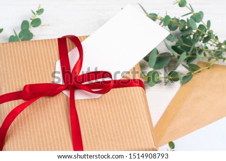 empty xmas wish list with little gift  on wooden background