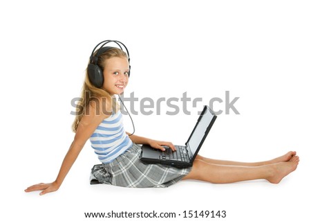 Teen girl on laptop with earphones isolated on white