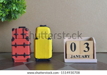 Appointment Date 3, Holiday, Travel cover with number cube and luggage.