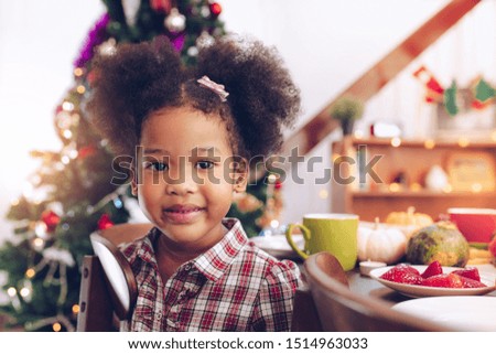 Little Girl Eating  and smile Thanksgiving Celebration Concept.Merry Christmas and Happy Holiday. Cute little child girl smile.