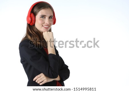 Women wearing black clothes, curly hair, wearing headphone listening to music.