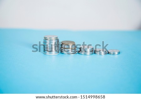 coins on the blue desk background .