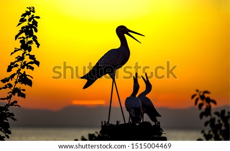 Stork nest silhouette at sunset Royalty-Free Stock Photo #1515004469