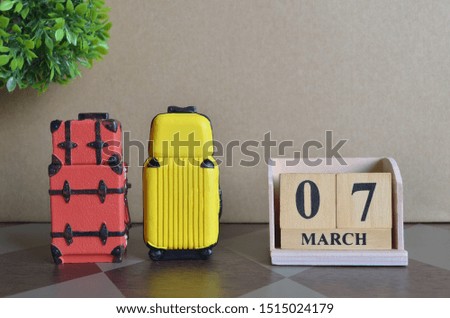 Appointment Date 7, March, Holiday, Travel cover with number cube and luggage.