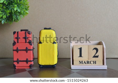Appointment Date 12, March, Holiday, Travel cover with number cube and luggage.