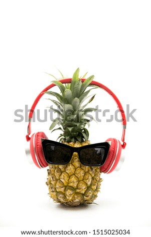full-size headphones on pineapple. Large over-ear headphones on the head, style and perfect sound. 