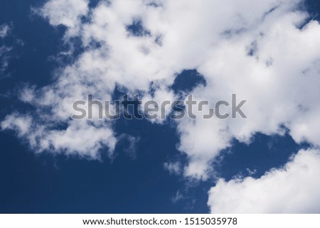 A fragment of a dark blue sky with clouds.