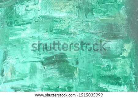 Colored canvas with oil paints in green colors. Bright saturated abstract background, copy space. The concept of a creative atmosphere, artistic events, education, etc.