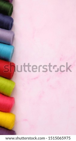 Colorful wool felt rolls in a row, with large empty space on the right.
