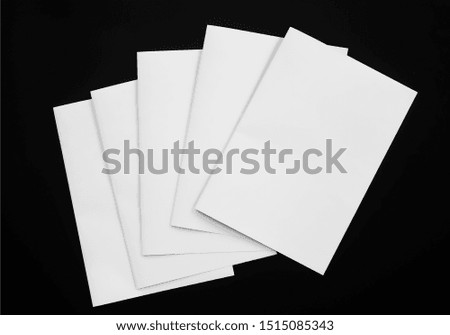 Top view of blank business cards isolated on black background. Poster mock-ups paper, white paper Blank portrait A4. brochure magazine isolated, use banners products business cards to showcase your 