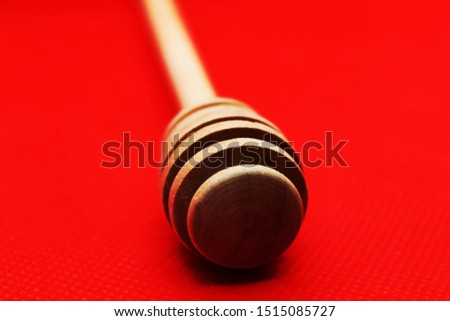 Sticks for honey on a red background