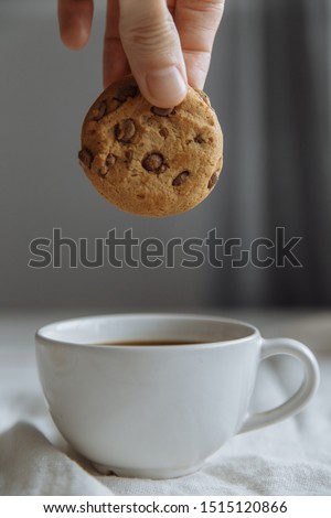 cookies on the white plate and coffee in white glass