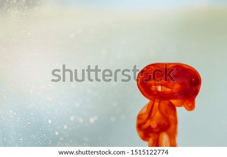 Abstract alien-like red food coloring bubble in sparkling water