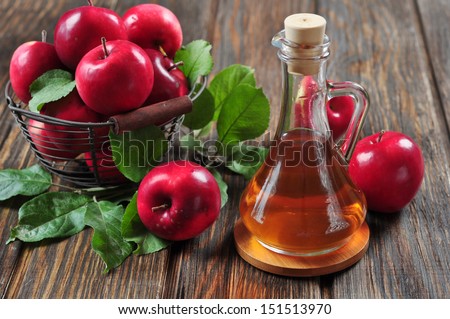 Apple cider vinegar in glass bottle and basket with fresh apples Royalty-Free Stock Photo #151513970