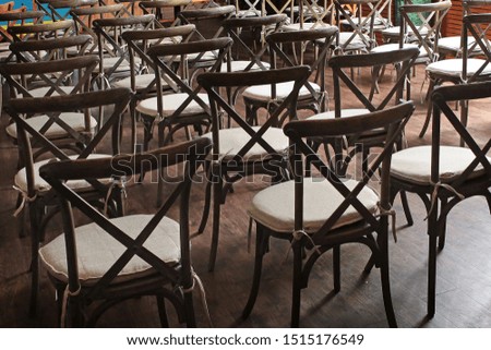 A large number of vintage wooden chairs in the basement. Conference venues. Photo in the interior. Top view.