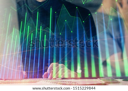 Forex graph with businessman typing on computer in office on background. Concept of analysis. Double exposure.