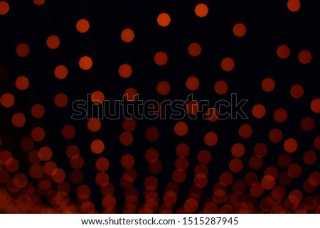 abstract unfocused picture of red bokeh illumination from some holidays decoration object in dark background environment 