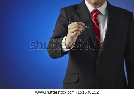 Businessman writing, drawing on the screen on a blue background