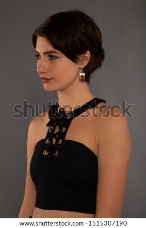Young brunette girl on grey background