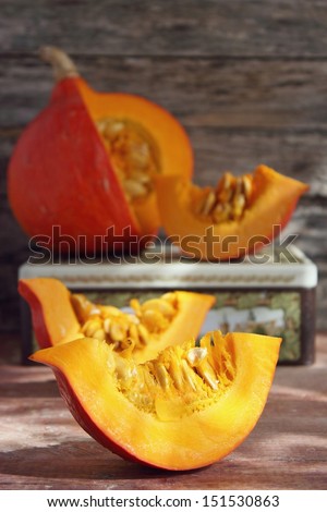Sliced pumpkin on wooden background
