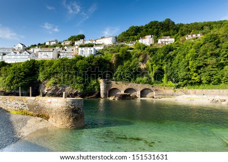 Looe harbour and river Cornwall England, with turquoise clear sea on a sunny summer day and town on the hillside Royalty-Free Stock Photo #151531631
