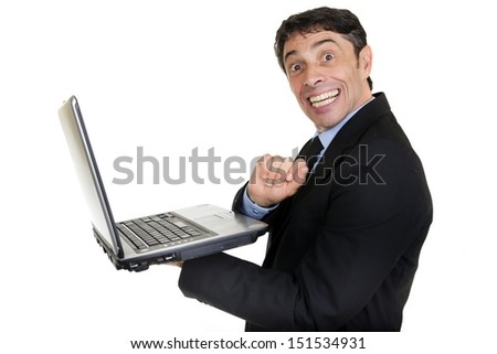 Fun portrait of a mature businessman holding an open laptop in his hand turning and giving a cheesy toothy grin of happiness to the camera isolated on white