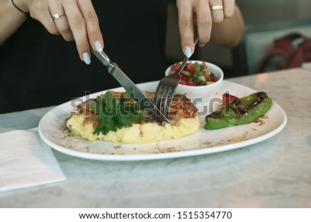 A young woman eats a tasty fresh Indian meals
