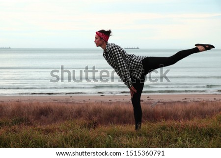 Young woman relaxing on the beach, meditation, Gisborne, New Zealand