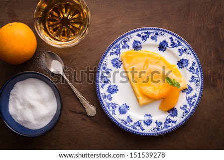 Traditional crepe suzette on wooden table overview Royalty-Free Stock Photo #151539278