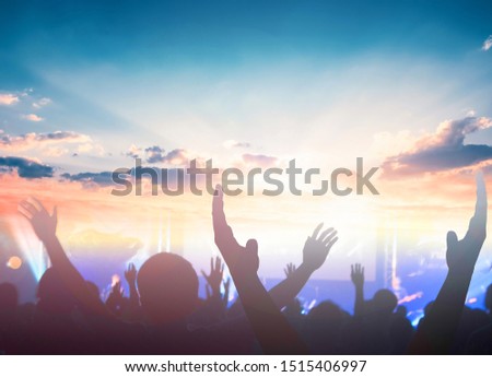 Worship and praise concept: christian people hand rising on sunset background Royalty-Free Stock Photo #1515406997