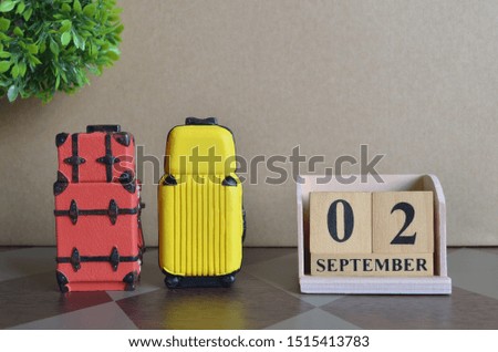Appointment Date 2, September, Holiday, Travel cover with number cube and luggage.