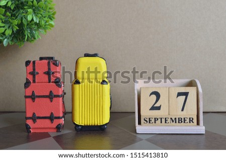 Appointment Date 27, September, Holiday, Travel cover with number cube and luggage.