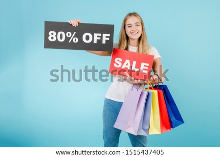 happy smiling woman with 80% off sale sign and colorful shopping bags isolated over blue