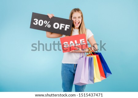 happy screaming blonde woman with 30% off sale sign and colorful shopping bags isolated over blue