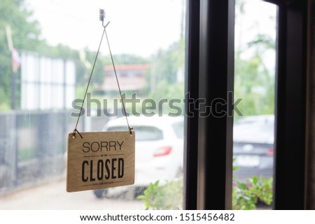 Close up sign hanging off Coffee shop door,Close sign blur background,Label word close