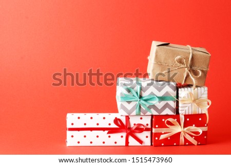 a lot of christmas gifts on a red background. top view. Place for text.
